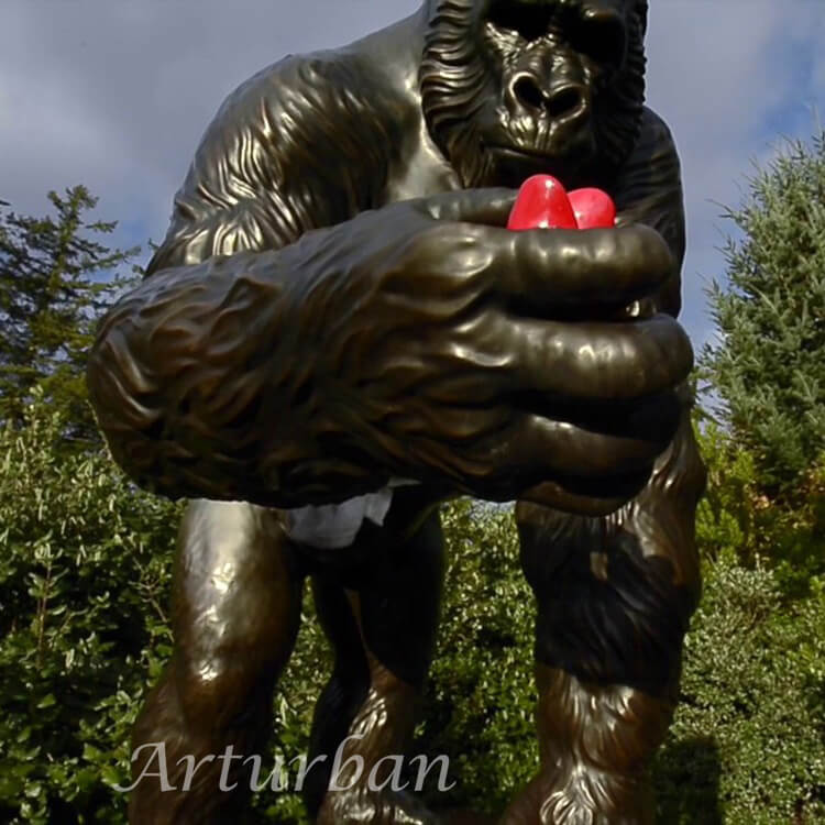 gorilla sculpture with red heart in hand