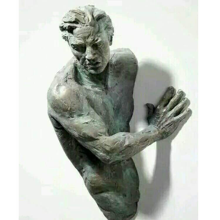 Man Coming Out of Wall Sculpture