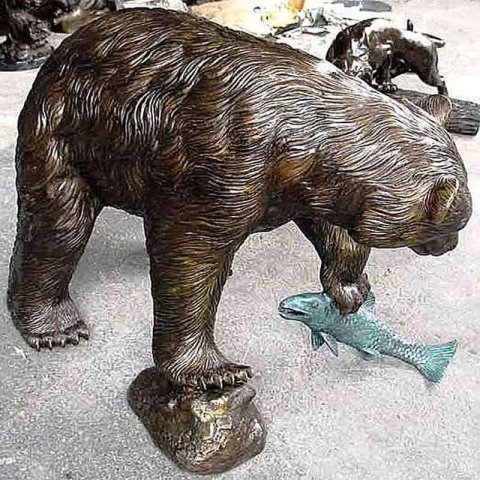 bear holding fish statue