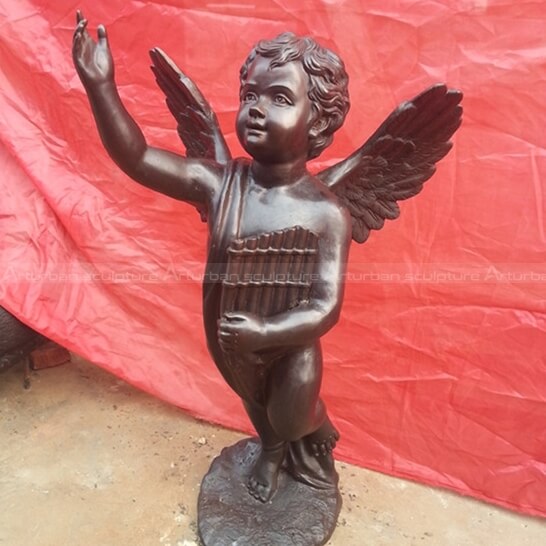 bronze cherub statue with organ