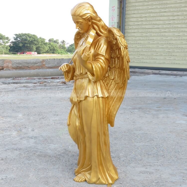 golden angel sculpture playing guitar