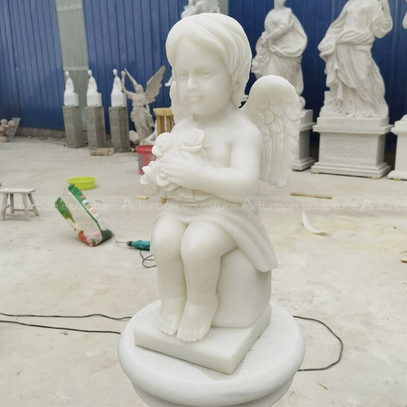 cherub angel statue with flower