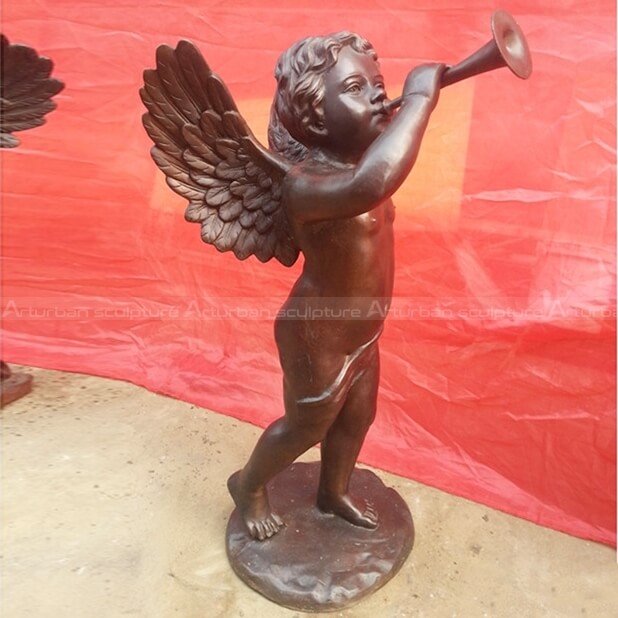 bronze cherub sculpture with trumpet