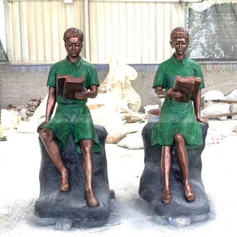 boy and girl reading statue