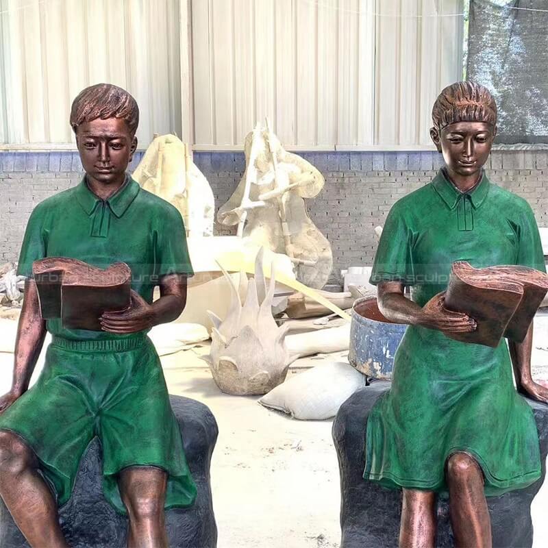 boy and girl reading sculpture