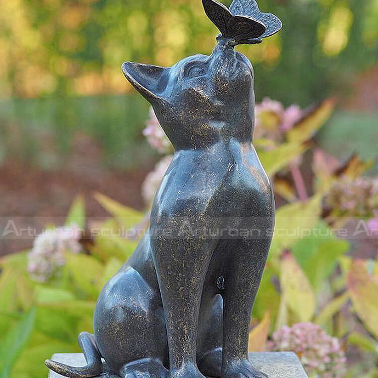 cat statue playing with butterfly