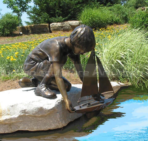 boy and boat sculpture