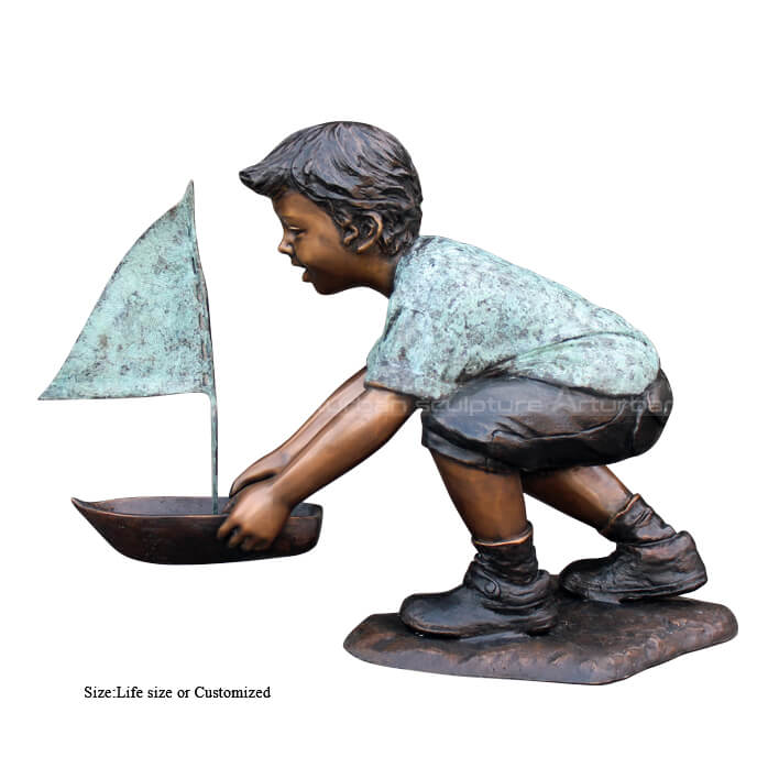 boy with boat sculpture