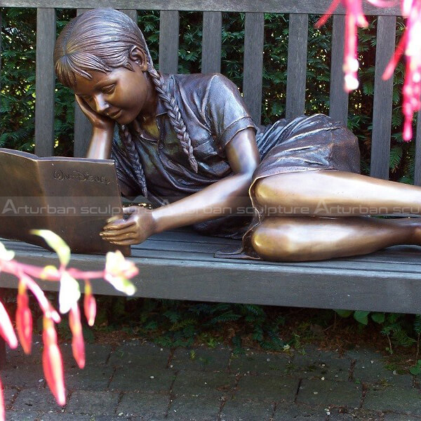 girl reading garden statue