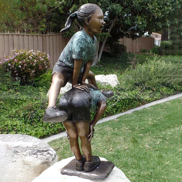 two girls playing leapfrog statue