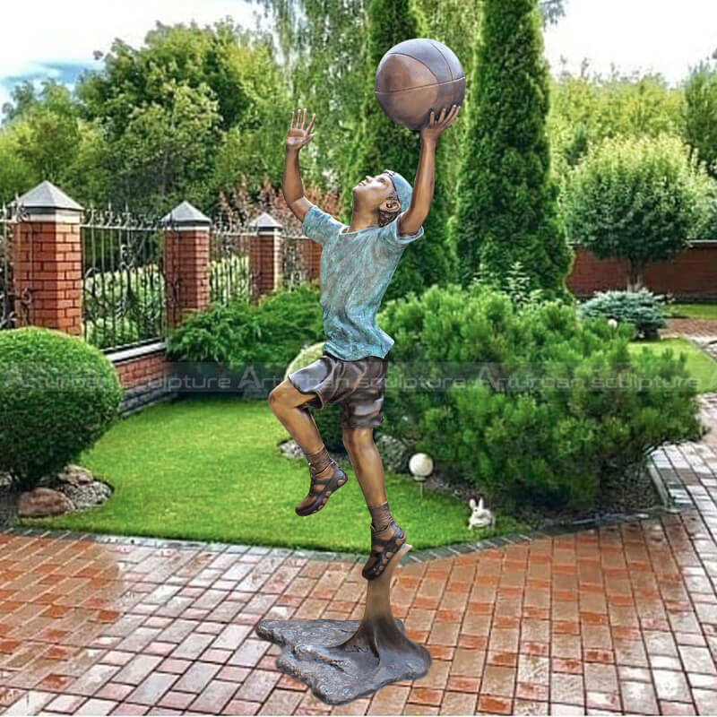 boy playing basketball statue