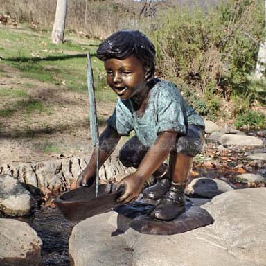 boy with boat sculpture