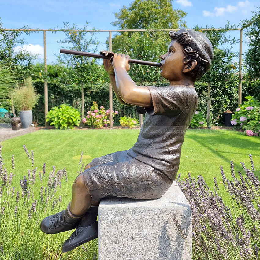 sculpture boy playing flute