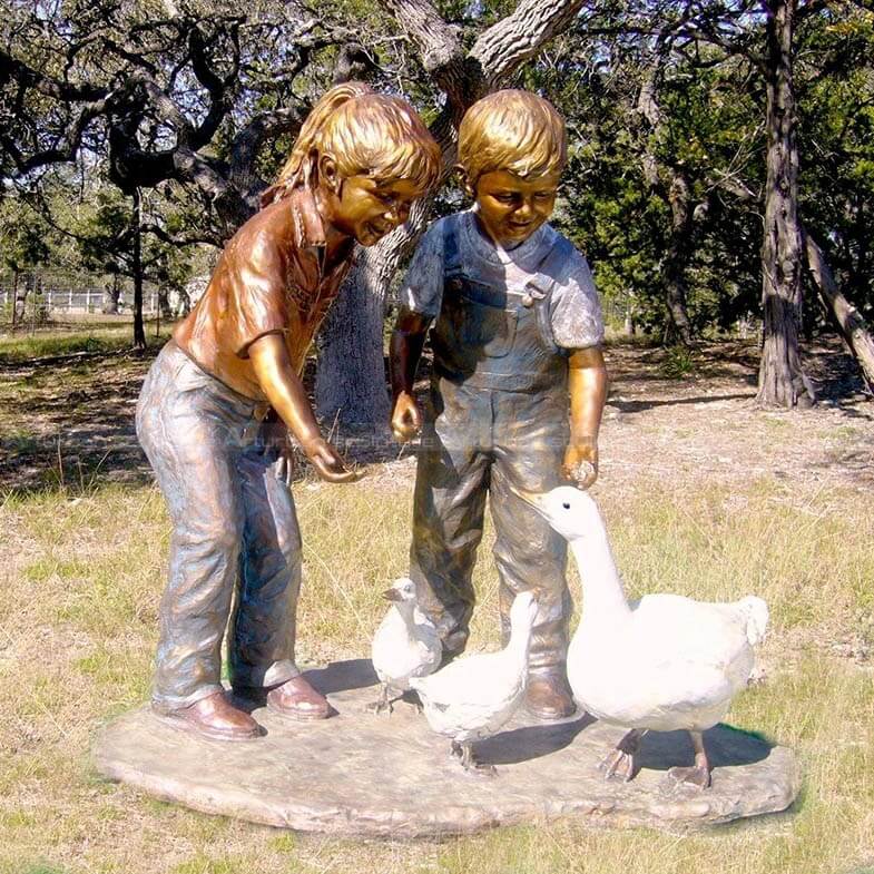 bronze boy and girl statue