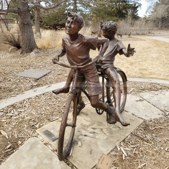 bike riding boy statue