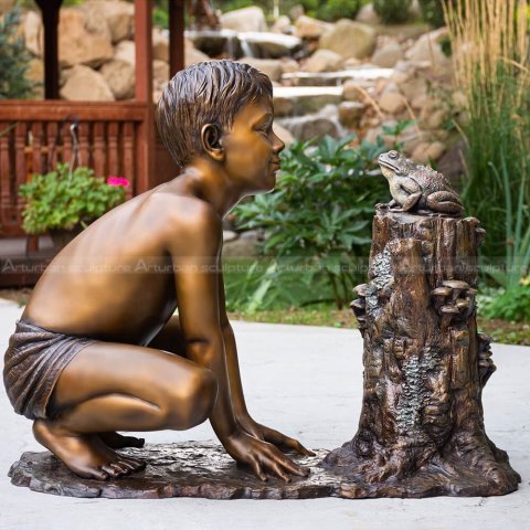 boy with frog sculpture