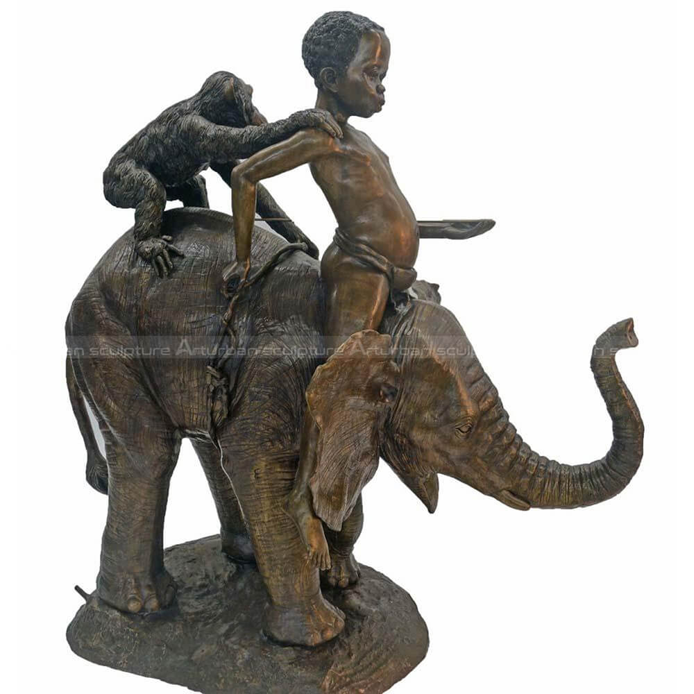 Boy sitting on elephant statue