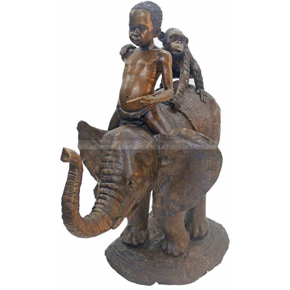 Boy sitting on elephant statue