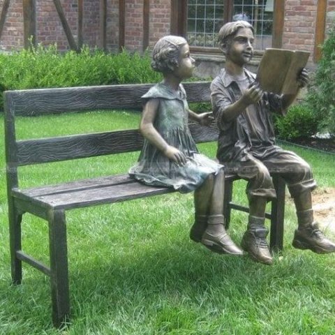 boy and girl on bench garden statue