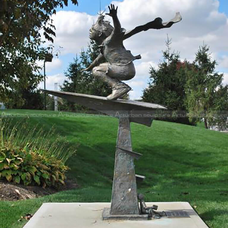 boy flying on paper airplane statue