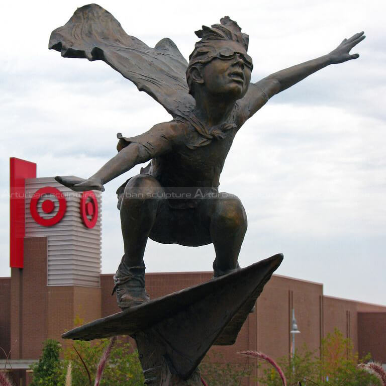 boy flying on paper airplane statue