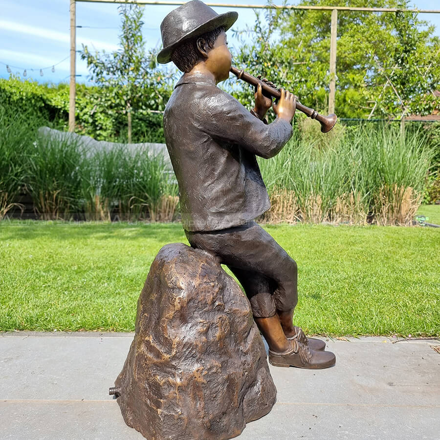 boy with flute statue