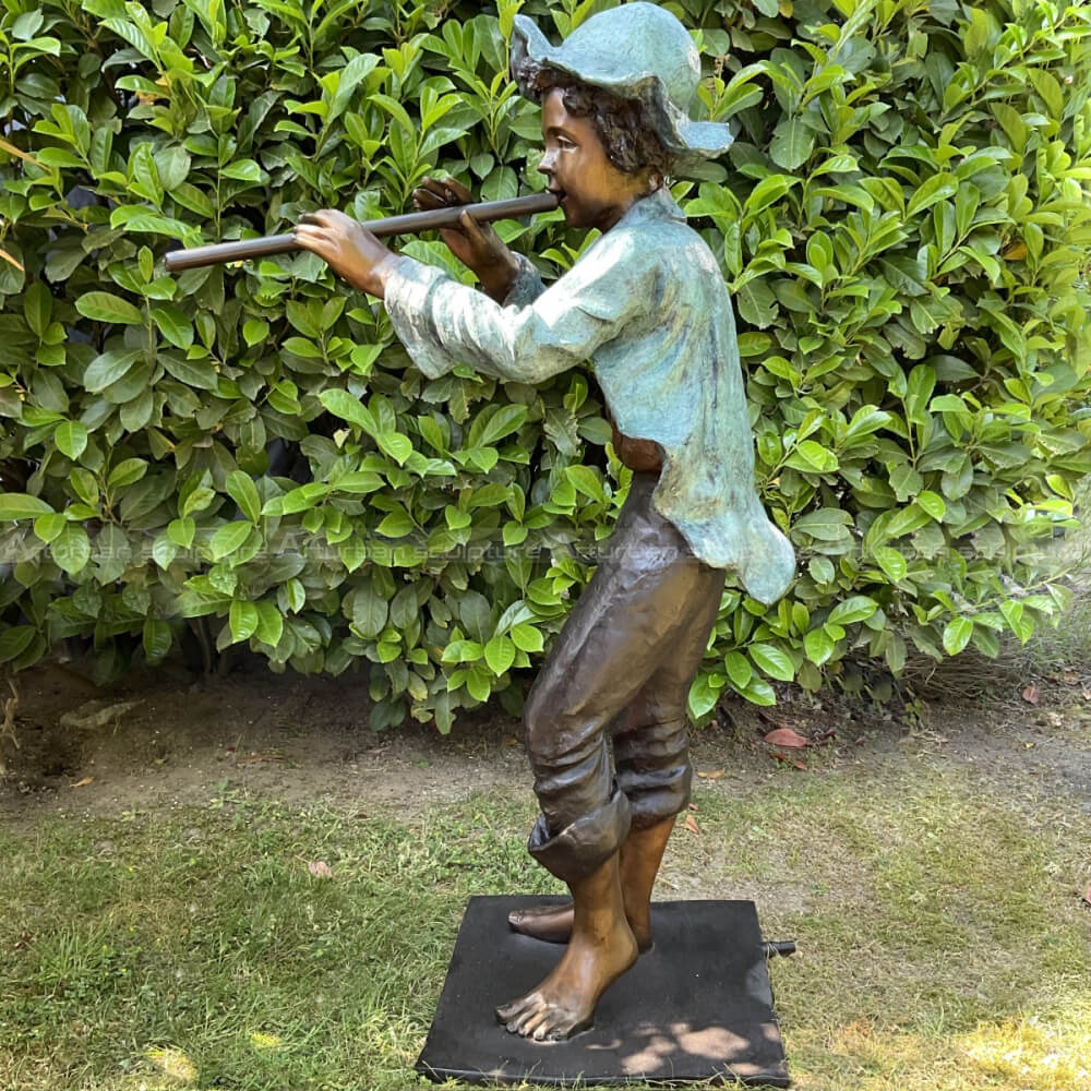 boy playing flute garden sculpture