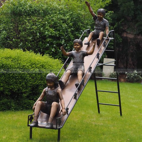 children on slide sculpture
