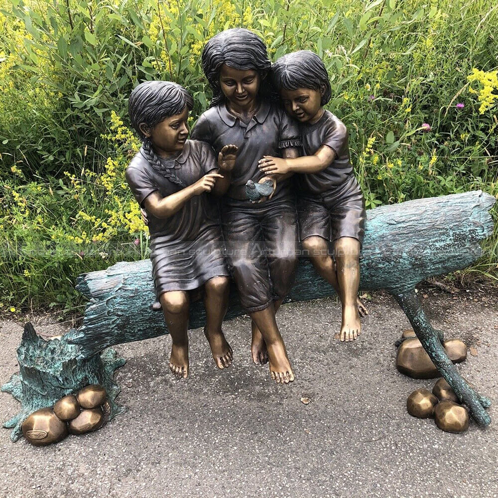 three kids on a log sculpture